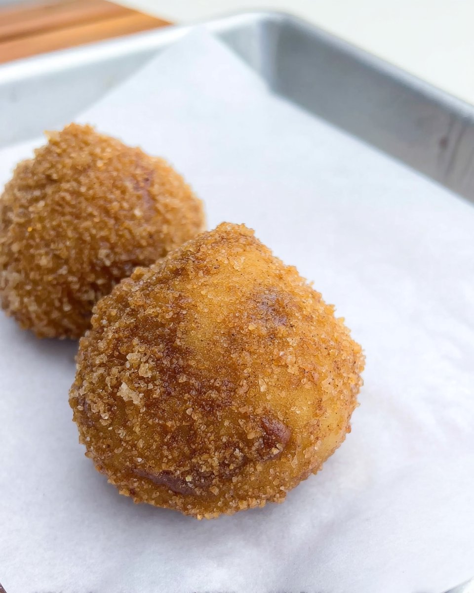 Rubbing orange zest into sugar to release oils