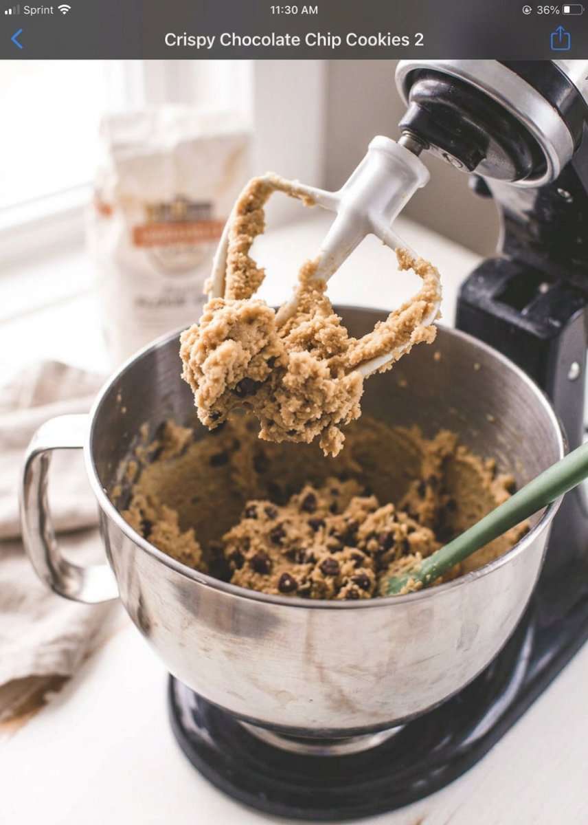 Ingredients for crispy chocolate chip cookies including honey, melted butter, and sugars.