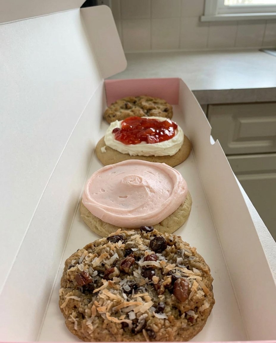 A close up of a thick chocolate chip cookie showing the soft center and golden edges