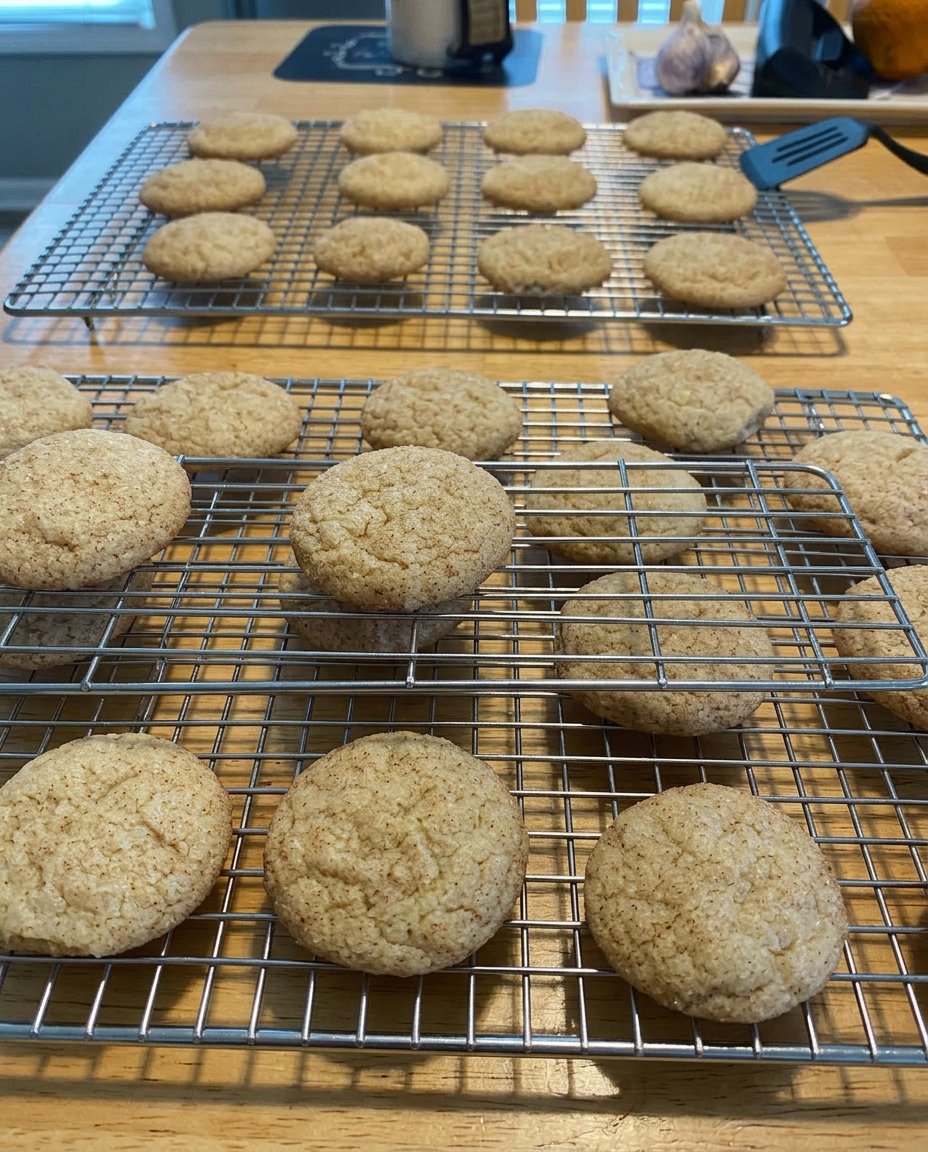 Gluten free snickerdoodles on a cooling rack with traditional cinnamon sugar coating