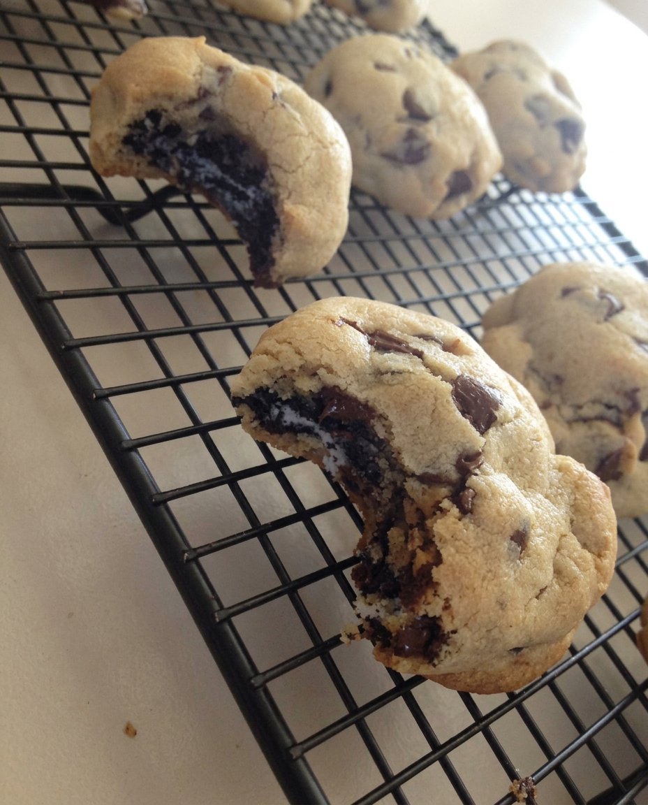 Cross section of an Oreo stuffed chocolate chip cookie showing the internal layers.