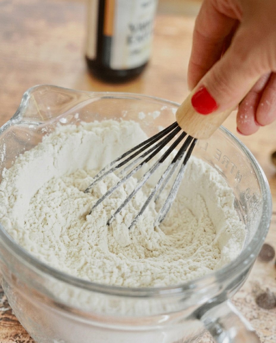 Ingredients for cherry cordial cookies including butter sugar flour and cherries laid out on a marble surface