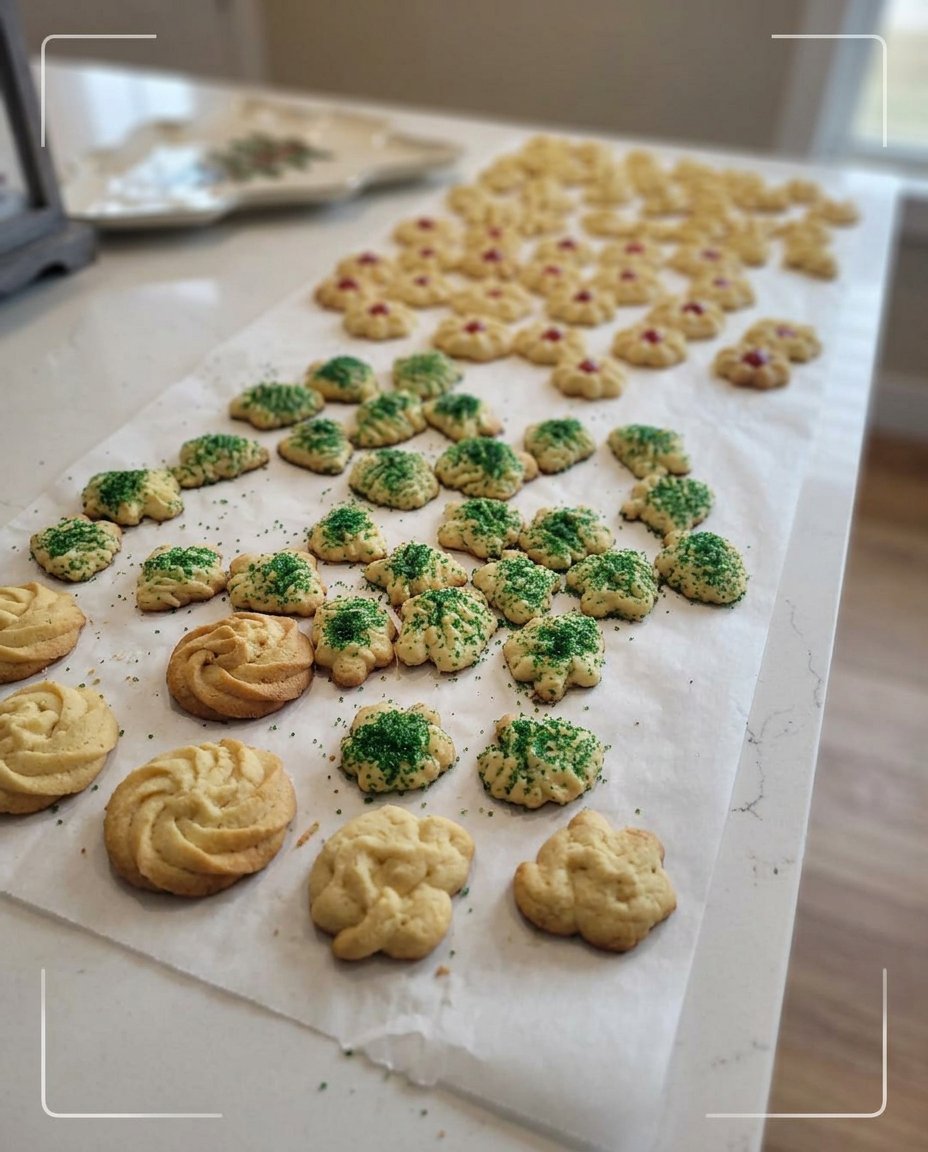 A close up of vanilla spritz cookies showing the intricate ridges from a traditional cookie press.