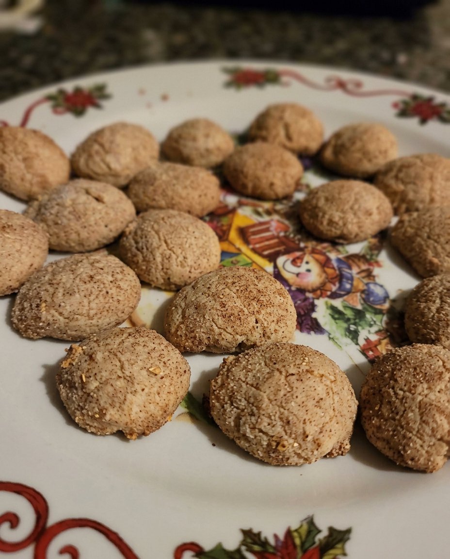 Freshly baked brown sugar cookies cooling on a wire rack next to a cup of coffee