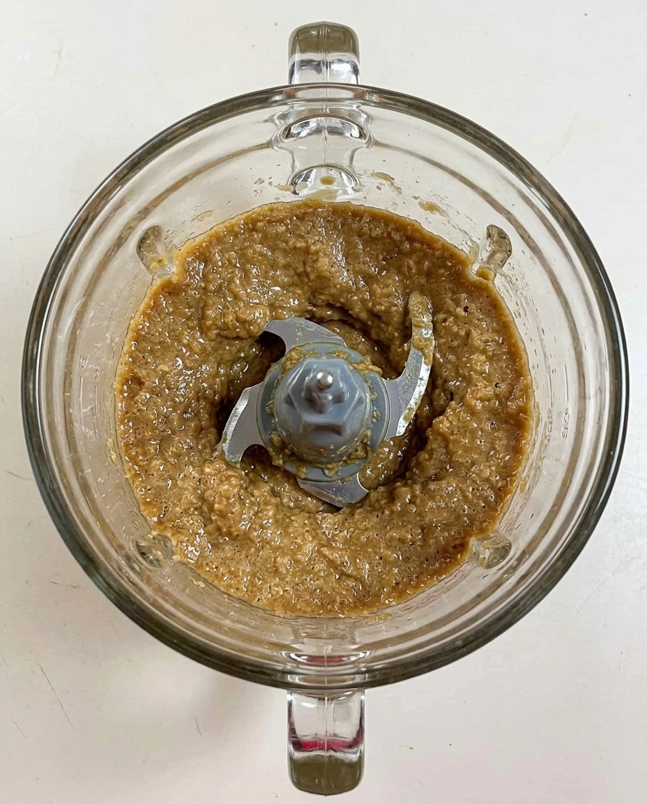 Hand holding gingersnap dough ball to show texture