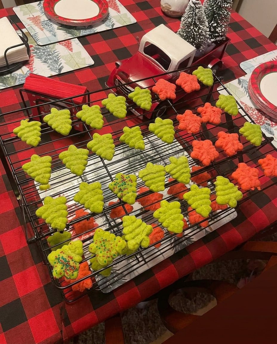 Perfectly shaped butter spritz cookies arranged on a wire cooling rack